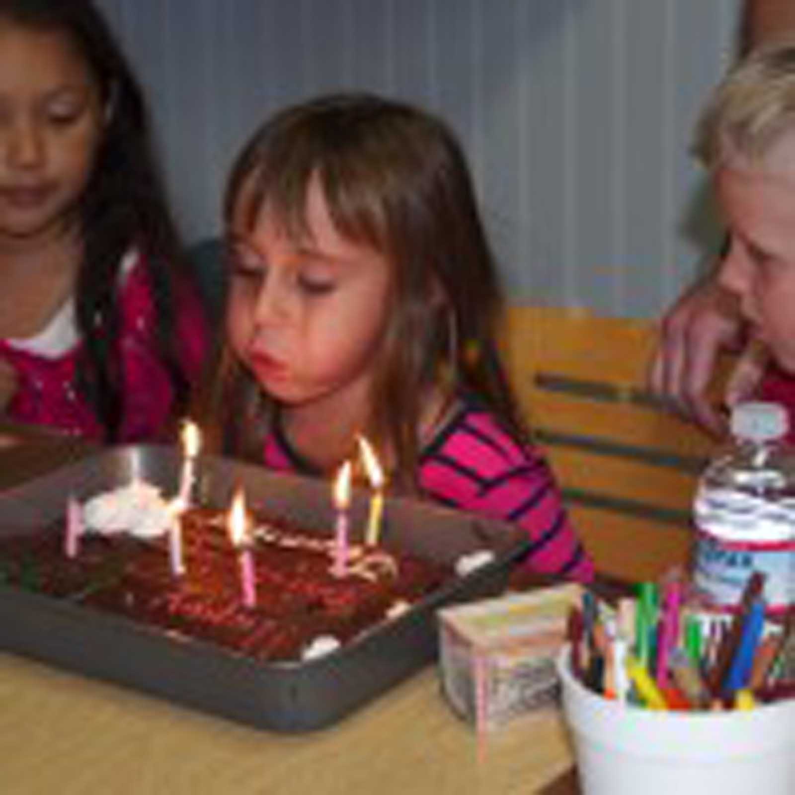 Blowing out her candles on her 6th birthday.