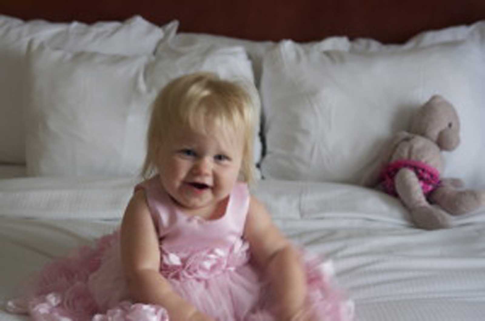baby Charlotte looked adorable in the flower girl dress that both girls wore.. I knew she wont fit in it for much longer so I chose it for our visit to the Hill. On the bed with pinkie behind her .. I took so many pictures..