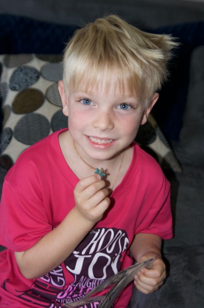 Jonathan wanted me to take a picture of him and his dragonfly necklace .