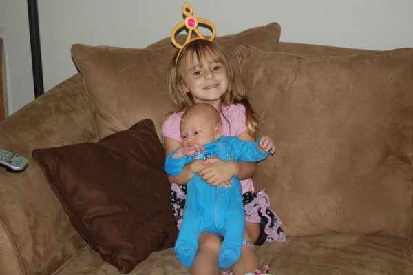 She loved holding him. From the very beginning she loved to be his big sister