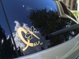 gold ribbon dragonfly decal on car